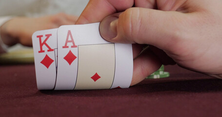 Croupier playing poker in casino. Close-up of hands and chips on table