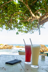 Refreshing drinks in the middle of scorching sun. Secret beach, Mirissa Sri Lanka. Relaxing under the shade of a tree with delicious drink on the perfect summer day. 