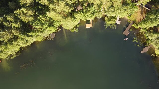 lake coast and a boat seen from above, the boat moore to the pier