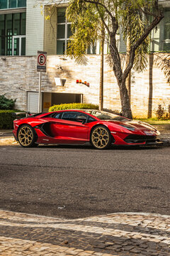 Rosso Khonsu Red Lamborghini Aventador SVJ front view, empty street, sunset light - High Resolution Image of a red sports car