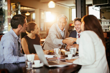 Office colleagues having casual discussion in cafe