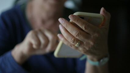 Close-up senior woman hands holding phone and texting message. Elderly lady using modern technology...