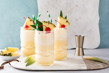 Pina colada in a tiki glass, tropical tiki cocktail with coconut and pineapple