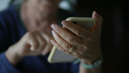 Close-up senior woman hands holding phone and texting message. Elderly lady using modern technology...