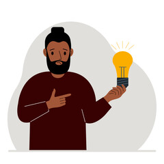 A man holds a light bulb in his hand. Idea concept, brainstorming, thinking, solution, eureka, task, bingo or search for an answer.