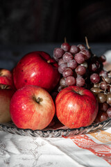 autumn still life. apples and grapes. fruits in a plate. red apple. food. fruits. autumn. 