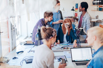 Obraz premium Diverse young office workers doing a project together