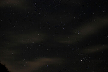 Starry sky with clouds at night in summer