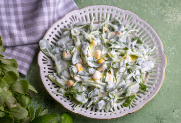 Purslane salad with yogurt in bowl on wooden background.