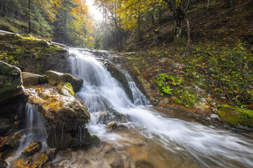 Autumn landscape with waterfall in a beautiful backlight. The rocky gorge Dolne diery in The Mala...