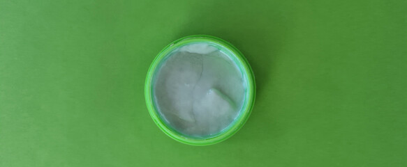 Face or body white cream hair balm green sage background