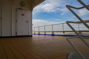 Outdoor promenade and pool decks of modern luxury cruiseship cruise ship liner with sun loungers...