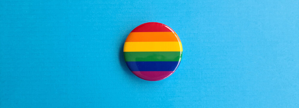 LGBT icon in shape of a circle on rainbow flag - Powered by Adobe