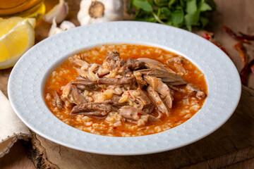 Turkish Soup Beyran with Lamb Meat, Rice, Chopped Garlic and Vinegar Sauce. Traditional Organic Food. Traditional soup of Gaziantep, Turkey. (Turkish name; Beyran corbasi)