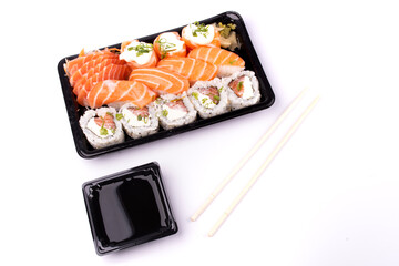 japanese oriental food sushi delivery isolated on background top view angled on white background with chopsticks and soy sauce