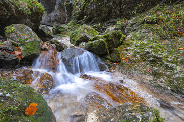Waterfall on a stream in forest at autumn.The rocky gorge Dolne diery in The Mala Fatra National Park, Slovakia, Europe.