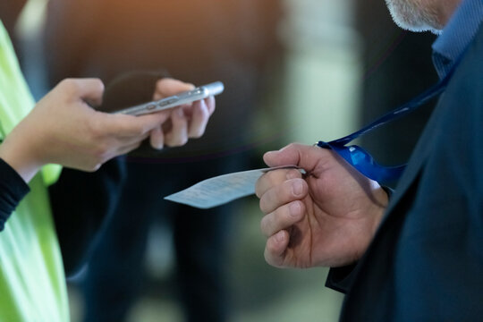 Event QR code ticket scanning. Businessman registering for a business conference using his smart phone