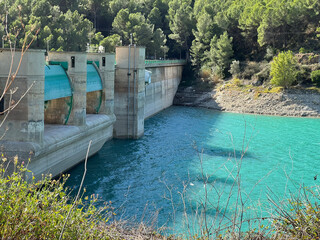 Panoramic view of a dam in a reservoir, in Guadalest village, Spain. The floodgates are open.