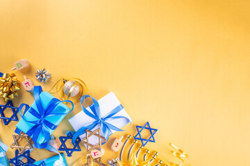 Happy Hanukkah greeting card background. Jewish New Year holiday flat lay with traditional symbols of hanukkah festival, menorah, donuts and decorations copy space