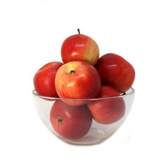 Ripe red apples in a glass bowl isolated on white background
