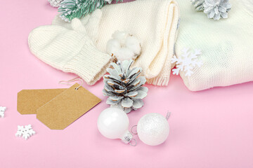 Cozy winter composition. Knitted mittens, warm scarf, traditional Christmas decoration