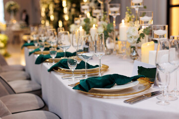 Wedding decorations. Served wedding table with decorative fresh white flowers, candles. Celebration...