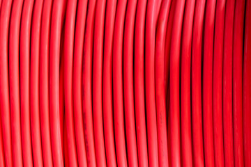 A coil of red electrical cable close-up.