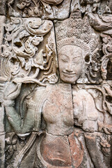 Fototapeta na wymiar Female sculpture on the facade of Angkor Thom Bayon, Angkor. Cambodia, Asia