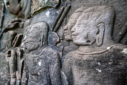 Male warriors with large earlobes carving on the facade of Angkor Thom Bayon, Angkor. Cambodia, Asia