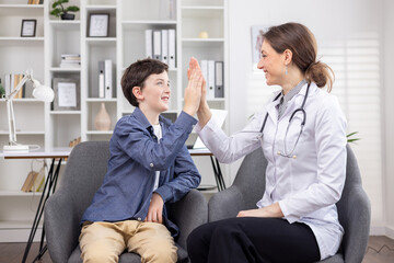 Teenage patient and female doctor give each other high five, successful reception consultation in...