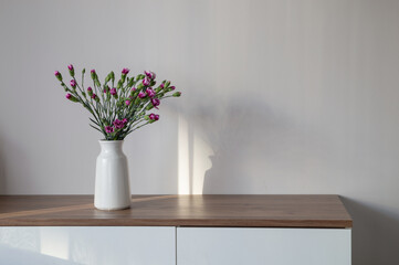 bouquet of purple carnation on background wall