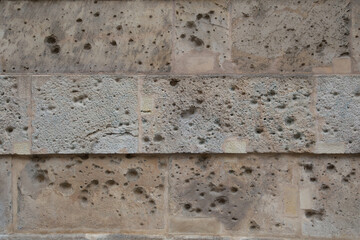 the old craked beige blocks wall