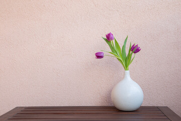 bouquet of purple tulips on background wall