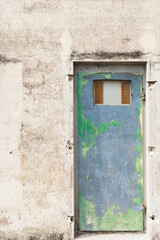 Fototapeta na wymiar Close-up of iron door on weather damaged wall