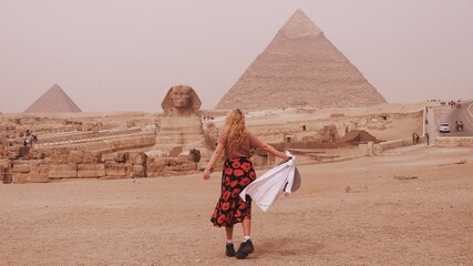 European woman a front of Giza pyramid in Cairo Egypt travel photography 