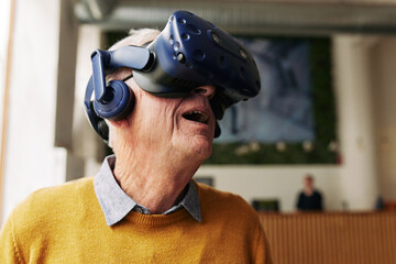 Senior man in awe exploring a virtual reality