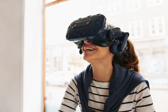 Laughing senior woman wearing a vr headset