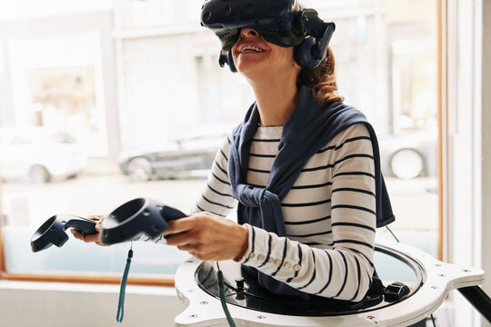 Senior woman using a vr headset and controllers
