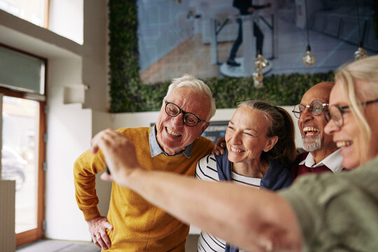 Smiling group of seniors taking selfies