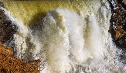 Spring landscape with waterfall on the northern river with stone banks