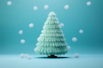 Knitted Christmas tree in pastel mint color. Creative copy space. Christmas and New Year, winter holidays greeting card.