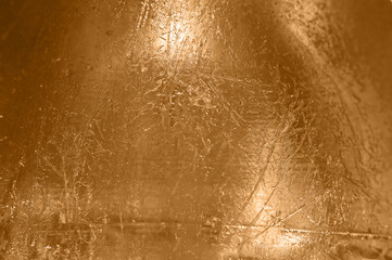 Golden brushed textured polished metal plate background.