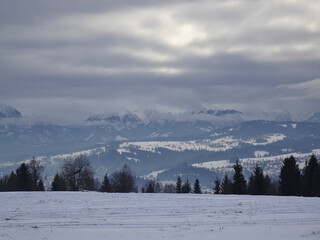 View of the snow-covered Tatra Mountains and Bukowina Tatrzanska on a cloudy and cold winter day, Bukowina Tatrzanska, Tatara Mountains, Poland.