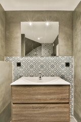 a bathroom with a sink and mirror in the corner, as seen from the top down to the floor below