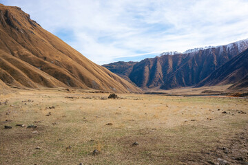 Vast Alpine Meadow Nestled Between Majestic Mountain Slopes, Peaceful High-Altitude Terrain