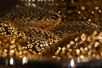 Golden gold christmas tree pine cones decoration, gilded an with xmas fairy lights. Glow and...