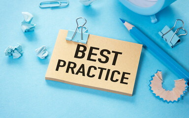Best practice text on white sticky note on blue background.