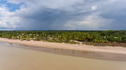 Aerial view of Awala-Yalimapo with dramatic sky and lush palms