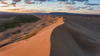 Vast Mongolian desert at dusk with sweeping sand dunes