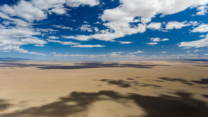 Fototapeta na wymiar Vast desert plain under Mongolia's cloud-filled sky.